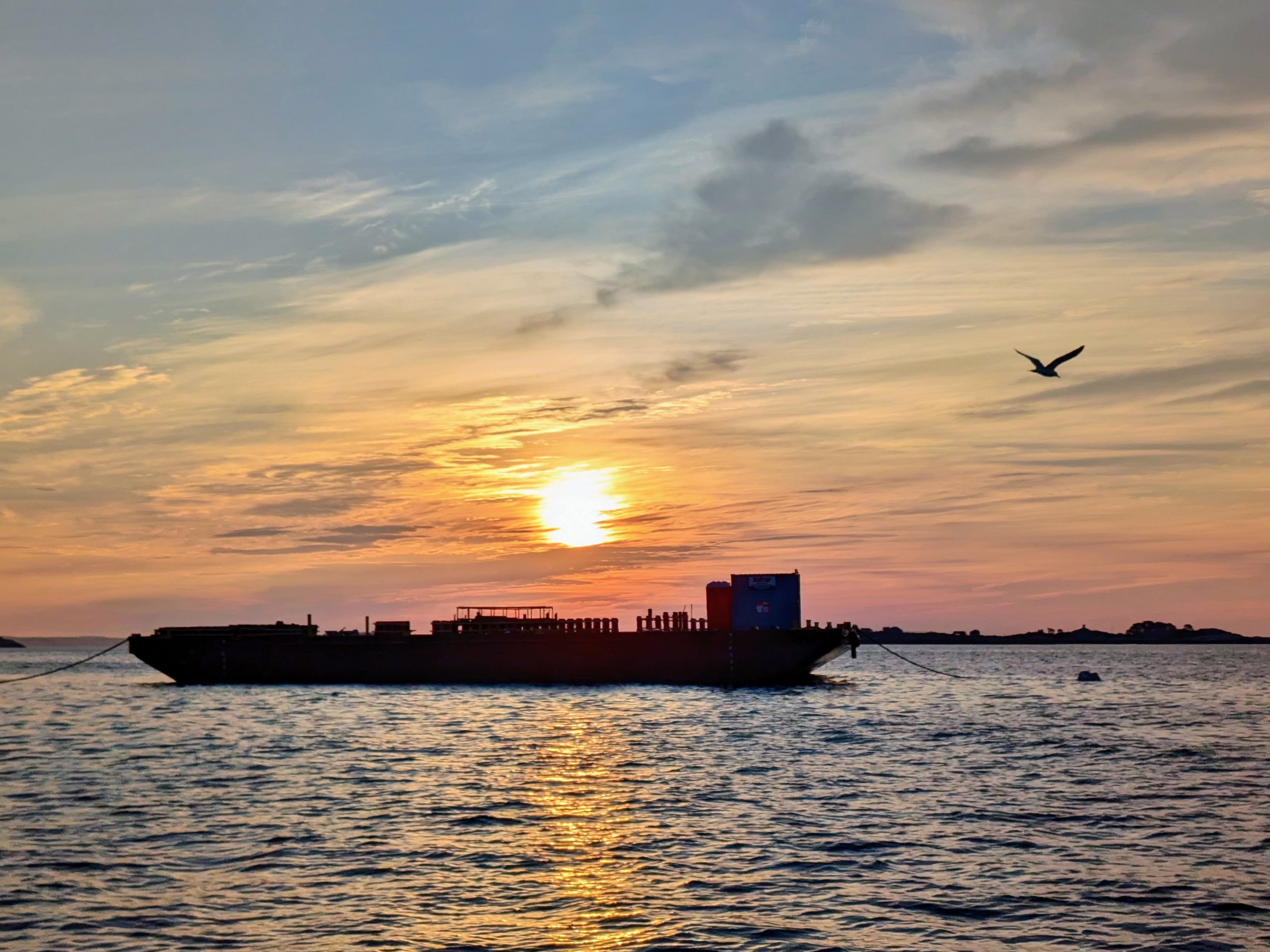 Sunrise over fireworks barge